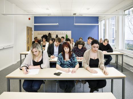 Large group of young adult students in the classroom