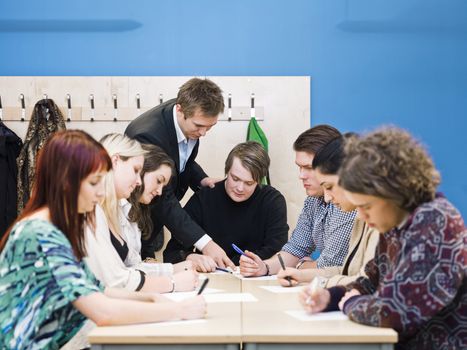 Teacher and young Adult students in the classroom