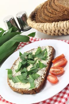 a slice of whole grain bread with butter and wild garlic