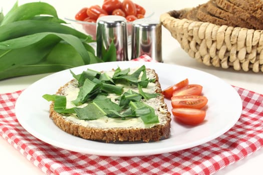 a slice of whole grain bread with butter and wild garlic