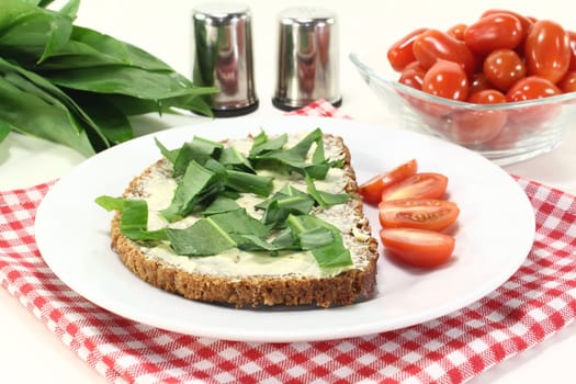 a slice of whole grain bread with butter and wild garlic