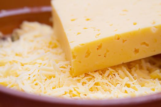 Cheese closeup and its shavings in plate