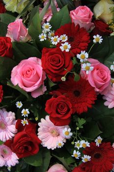 gerberas and roses in a red and pink mixed flower arrangement