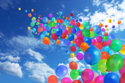 Lots of colorful balloons flying on blue sky background