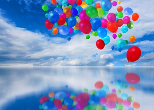 Colorful balloons on mirror cloudscape background