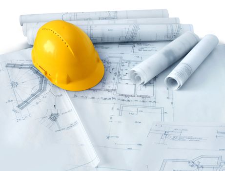 Construction plans drawings rolls and yellow hard hat helmet