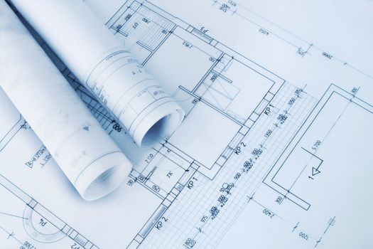 Construction plan blueprint rolls with drawings