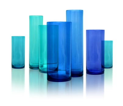 Seven modern blue glass vases row on white reflective background