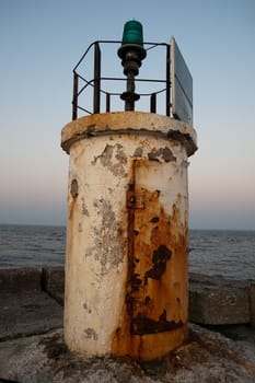 old metal lighthouse at the end of a  pier