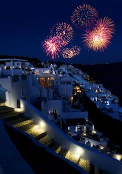 Fireworks night over Greek holiday resort Oia village Santorini