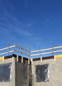 Building with working safety guard rails under construction