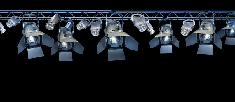 Professional stage spotlight lamps rack on black background