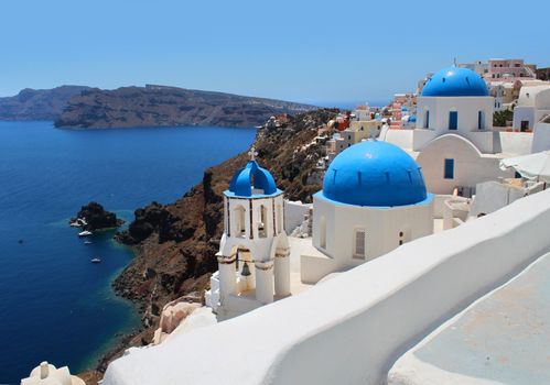 Santorini caldera sea view, church towers and blue cupolas