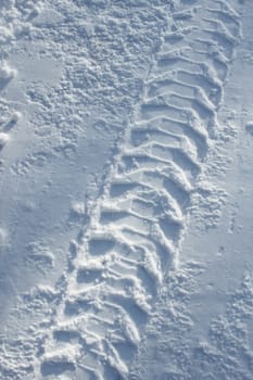 Heavy vehicle tyre track in pure white snow