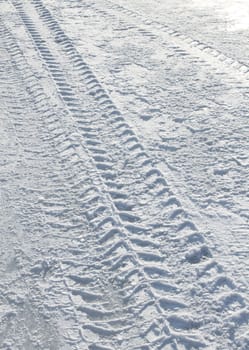 Vehicle tyre tracks on snowy slippery road