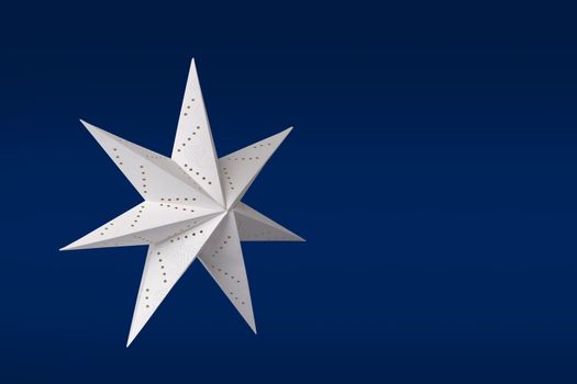 White Christmas paper star on dark blue background