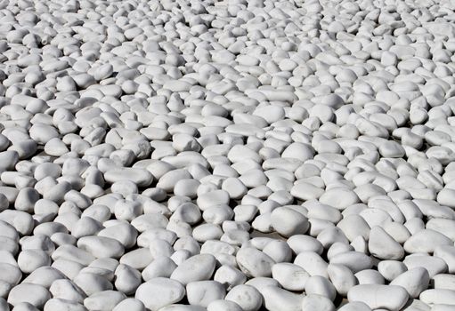 Smooth shaped white stones surface texture background