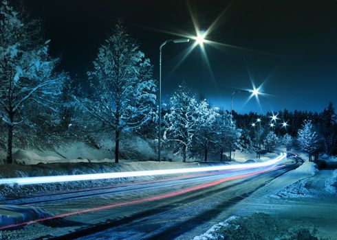 Small town street traffic on dark cold winter evening