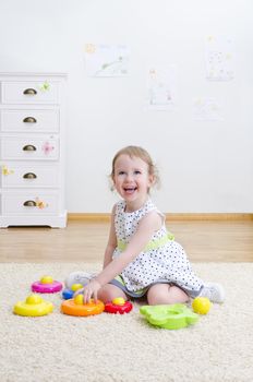 Little girl playing in a pyramid toy