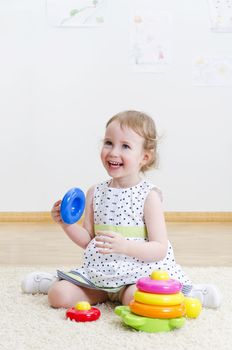 Little girl playing in a pyramid toy