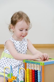 Little girl playing in a developing toy