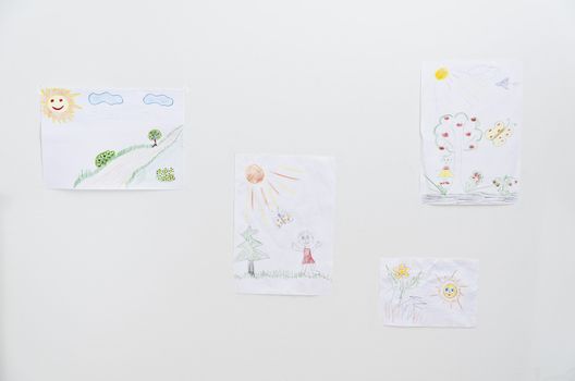 Collection of children's drawings on the wall