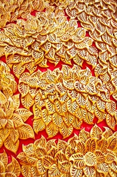 The gold stucco design of native thai style on the Wall