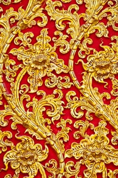 The gold stucco design of native thai style on the Wall