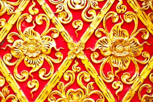 The gold stucco design of native thai style on the Wall