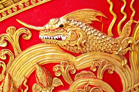 The gold stucco design of native thai style on the Wall