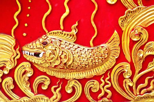 The gold stucco design of native thai style on the Wall