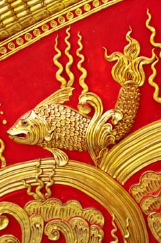 The gold stucco design of native thai style on the Wall