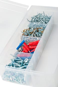 Nails and screws in box on white background