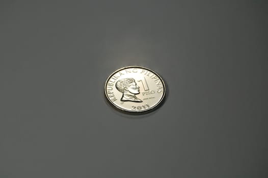 A shiny silvery 1-peso coin