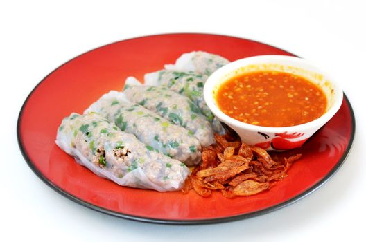 Vietnamese rice noodle rolls with a filling of pork sliced and vegetable ,  fried onion served with spicy sauce