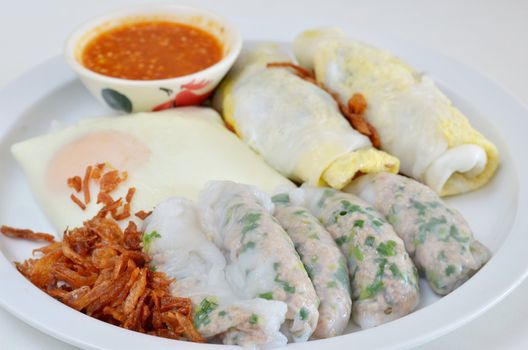 mixed vietnamese rice noodle rolls with a filling of pork sliced , egg and vegetable ,  fried onion