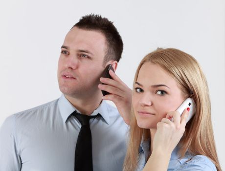 Close-up of a young couple using mobile phones.