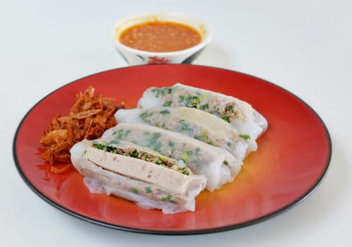 Vietnamese rice noodle rolls with a filling of pork sliced , vietnamese sausage and vegetable served with  fried onion and spicy sauce