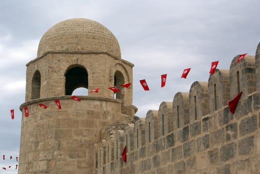 Fortress and red flags in medina of Sousse, Tunisia               