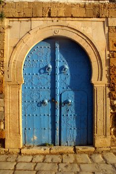 Blue iron door and wall on the street of Sidi Bou Said, Tunisia              