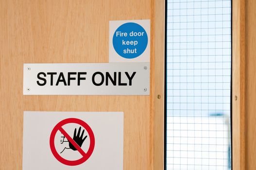staff only door signs outside laboratory room to assure health and safety in the workplace