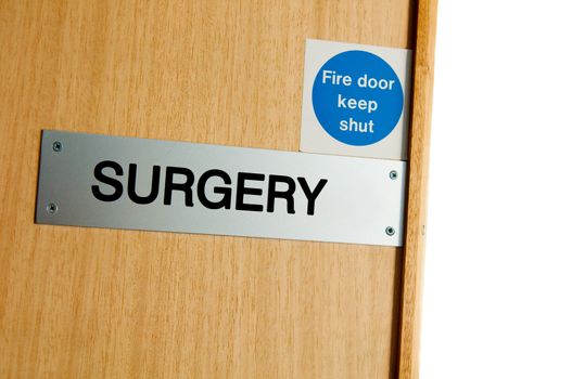 surgery sign at a wooden door (copy-space available, isolated on white)