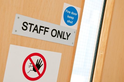 staff only door signs outside laboratory room to assure health and safety in the workplace (shallow DOF)