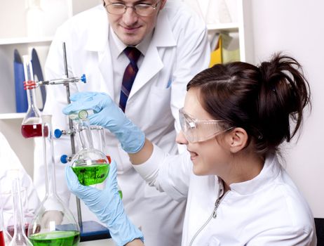 Chemists working with a team looking at the tube