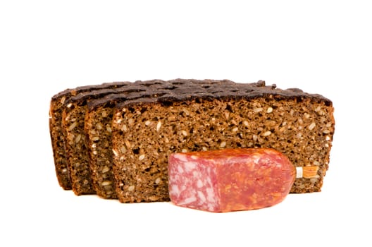 cut smoked sausage and dark bread with grain pieces isolated on white background. Healthy natural food.