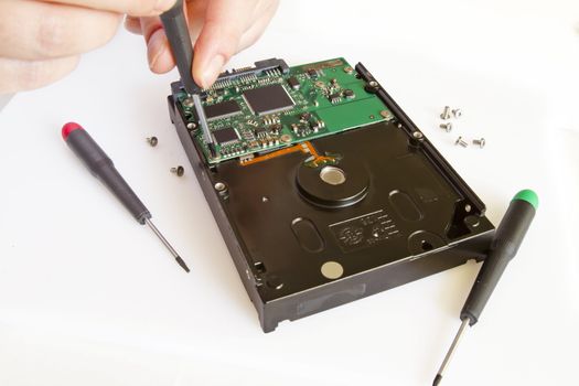 Technical surgeon working on hard drive - data recovery concept