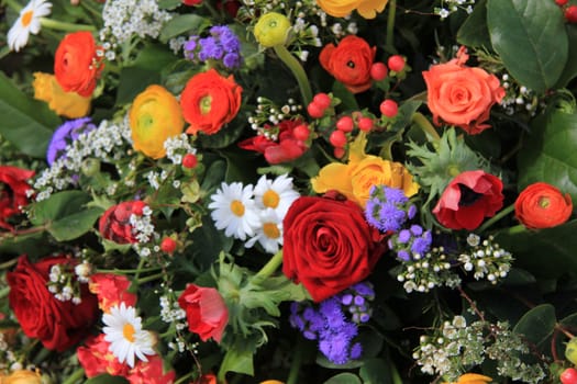 Flower arrangement in many bright colors and different sorts of flowers