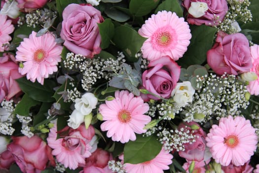 pink rose and gerbera in a pink and white flower arrangement