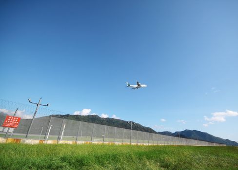 Airplane flying in green airport