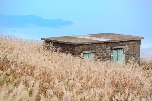 old stone house with grass on the mountain 